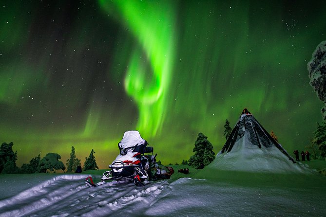 Hunting Northern Lights by Snowmobiles - Riding into Saariselka after dark