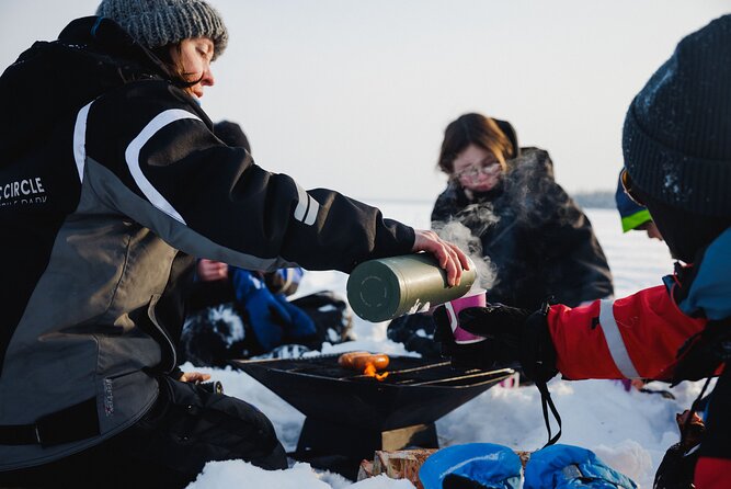 Ice Fishing and Snowmobile Safari Combo in Lapland - The campfire stop, sausages, and warm drinks