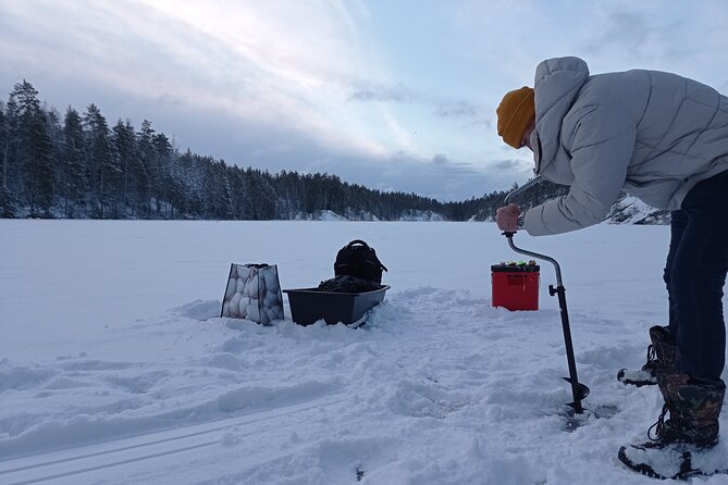 Ice fishing experience with Backpacker Helsinki Tour - Learning to fish through the ice
