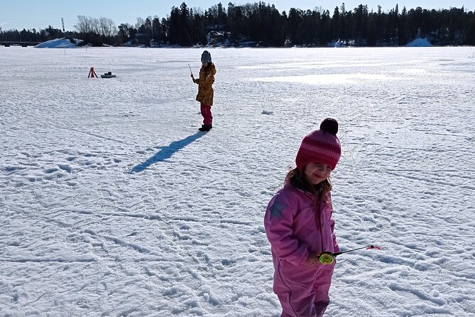 Ice fishing experience with Backpacker Helsinki Tour - Standing on a frozen lake