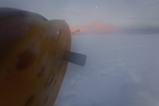 Ice fishing experience with Backpacker Helsinki Tour - Fire, sausage, and Finnish winter treats