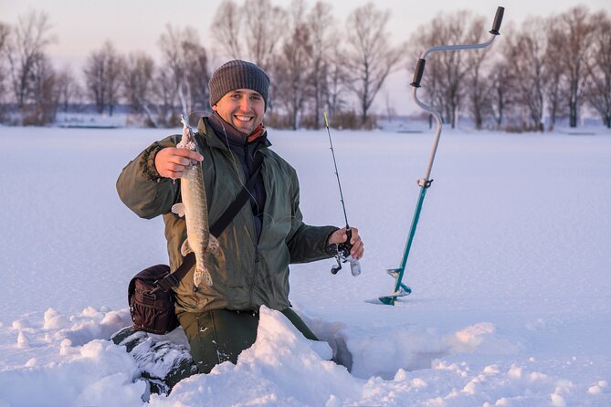 Lapland Ice Fishing Experience from Rovaniemi - Drilling through thick ice for the first time