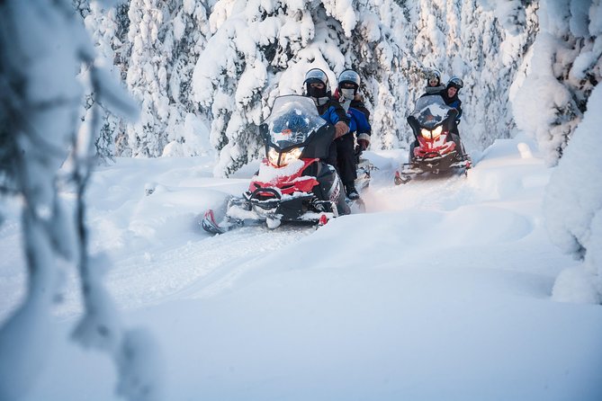 Lappish Lunch Break -Snowmobiling, ice fishing and tasty food - Cutting a hole in the ice