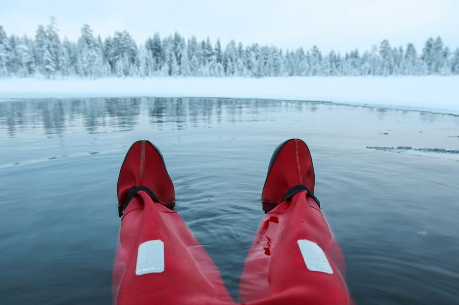 Levi: Arctic Ice Floating Adventure - Entering the water with a guide nearby