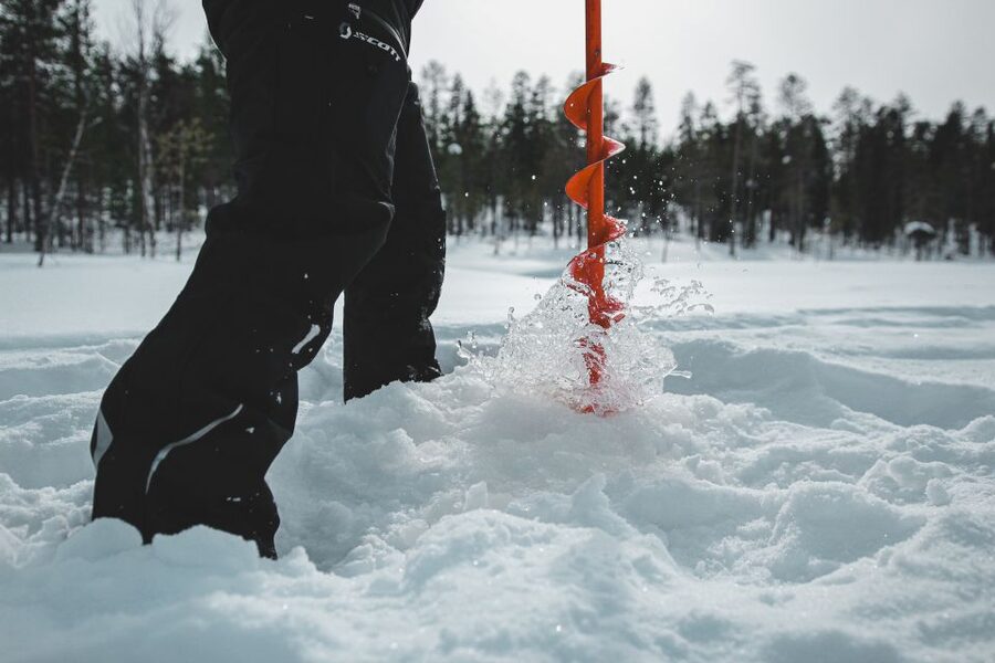 Levi: Finnish Ice Fishing Tour by Car - Drilling through the ice and setting the rod