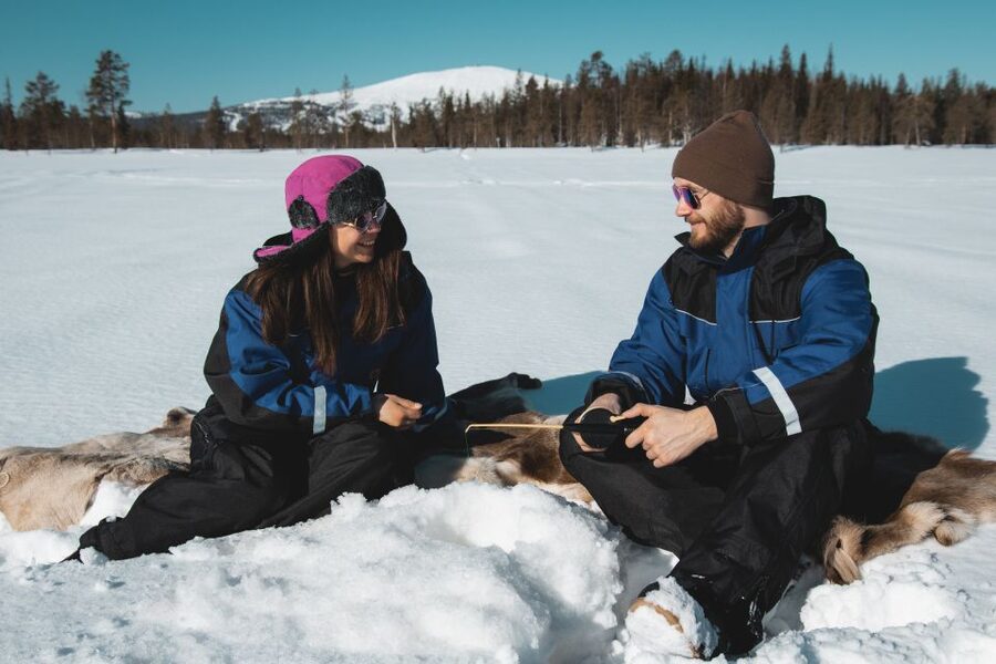 Levi: Finnish Ice Fishing Tour by Car - Warming up beside the campfire