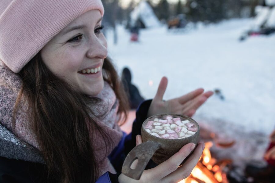 Levi: Snowmobile Safari with Ice Fishing and Outdoor Lunch - Warming up with Finnish soup by the fire