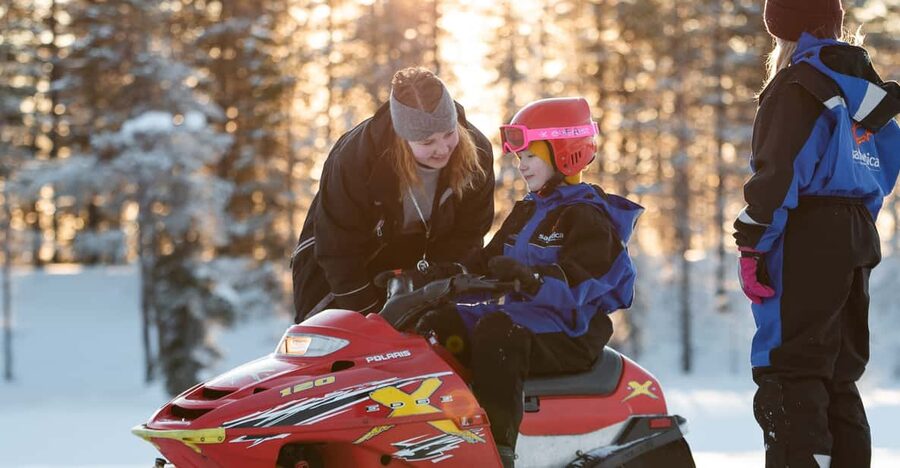Rovaniemi: Family Snowmobile Trip with Guide and Picnic - Adult snowmobiling through Rovaniemi’s snowy wilderness