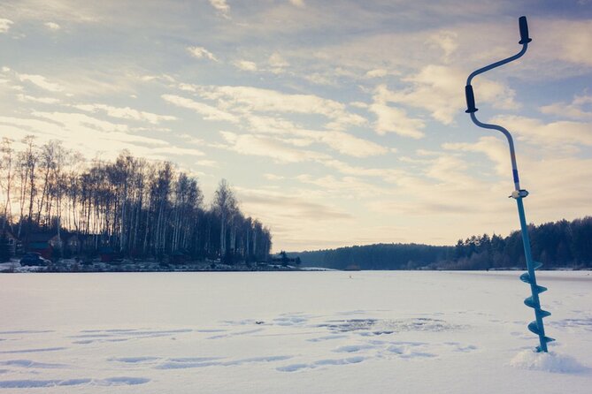 Rovaniemi: Ice Fishing from Private Lakefront Property & BBQ - Learning how to fish through the ice