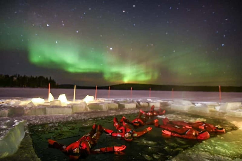 Rovaniemi: Ice Floating in Forest Lake with Aurora Borealis - Getting into the floating suit