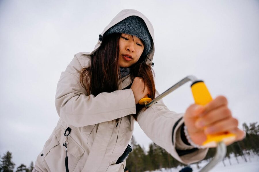 Saariselkä: Ice Fishing Adventure - Drilling a hole through thick Finnish ice