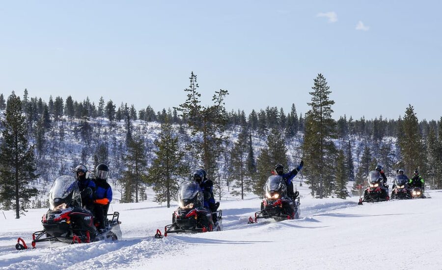 Saariselkä: Ice Fishing Safari by Snowmobile - Drilling through the frozen lake